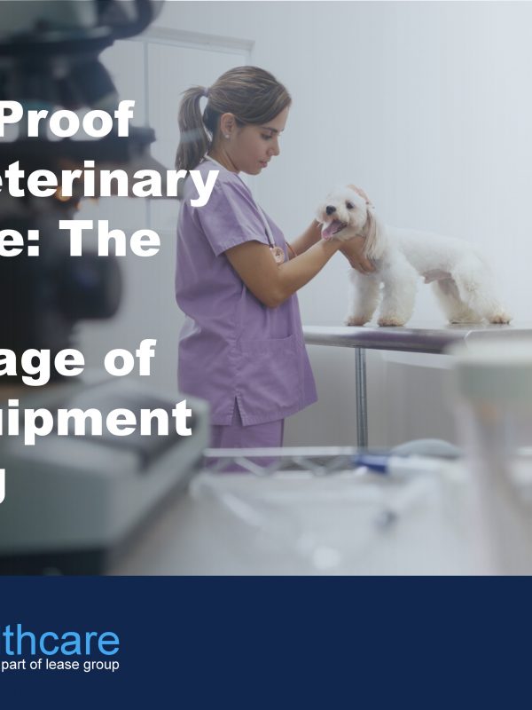 Image of veterinary examination room and a nurse in pink scrubs stroking a small white dog to demonstrate the benefits of vert equipment leasing